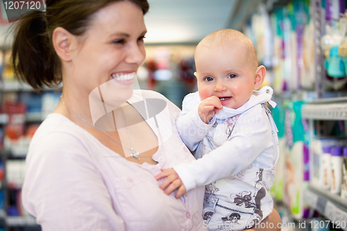 Image of Cheerful mother and baby in shopping centre