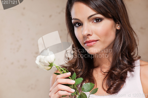 Image of Attractive young female holding a white rose