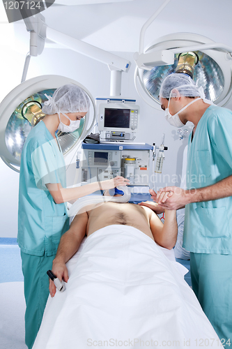 Image of Patient being operated by the surgeons