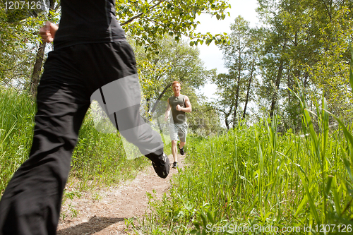 Image of Friends jogging in forest