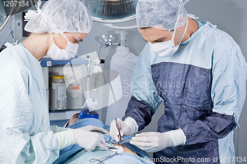 Image of Medical professionals carrying on surgery on patient