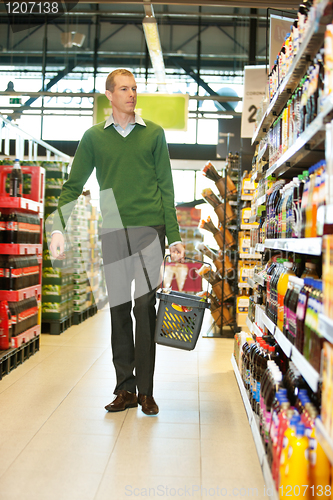 Image of Man walking in grocery store