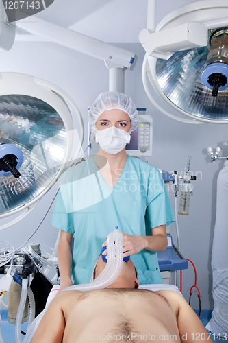 Image of Doctor applying gas mask to a patient