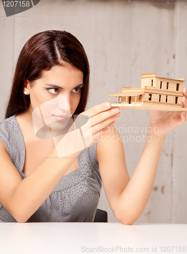 Image of Designer Examining Model House