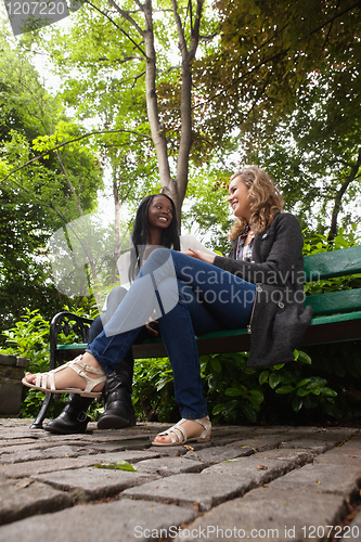 Image of Young females talking to each other in park