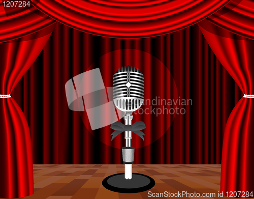 Image of A microphone on a stage with a spotlight on it.