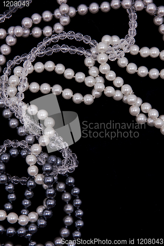 Image of White and black pearls on the black silk
