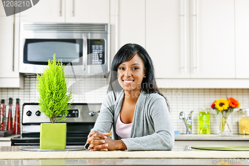 Image of Young woman in kitchen