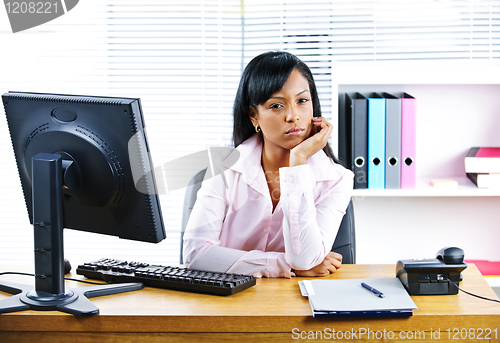 Image of Angry businesswoman at desk