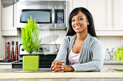 Image of Young woman in kitchen