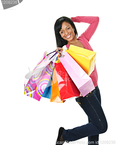 Image of Young excited black woman with shopping bags