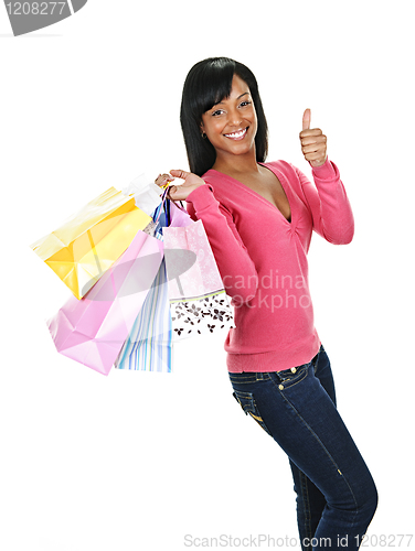 Image of Young happy black woman with shopping bags