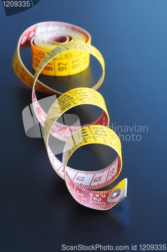 Image of measuring tape on blue background