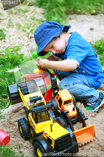 Image of Boy playing with digger