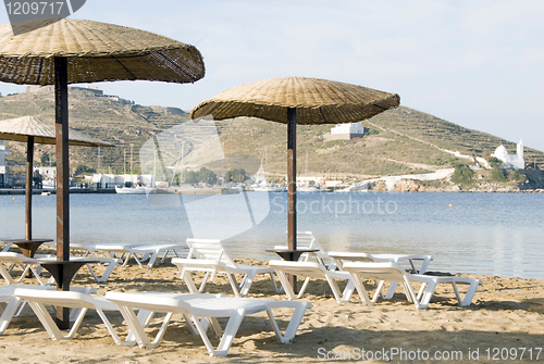 Image of beach with umbrellas lounge chairs Ios Island Cyclades Greece