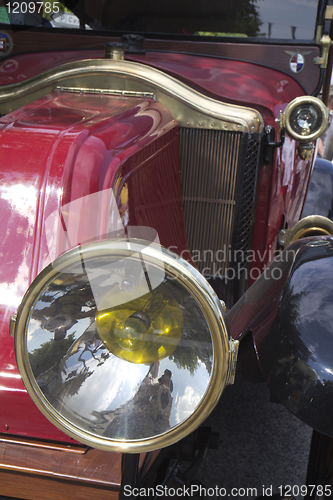 Image of  Detail of a red classic car with headlight