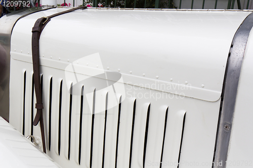 Image of  Bonnet of a classic car locked  by a strap