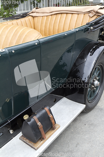 Image of Green vintage car with gas tank on the running board.