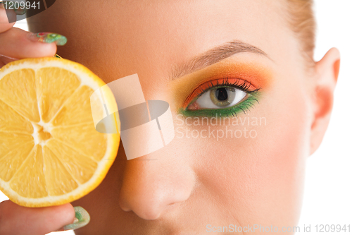 Image of woman holding lemon