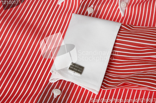 Image of cuff link on men's red shirt 