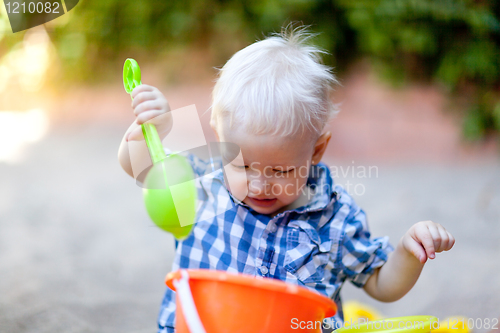 Image of toddler playing in sand