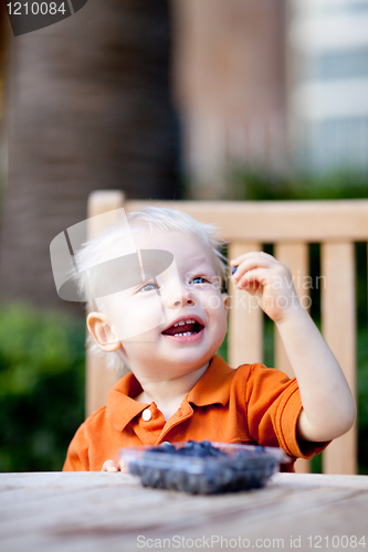 Image of toddler eating berries
