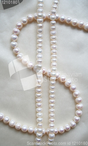 Image of  Pearls on the smooth elegant white silk as background