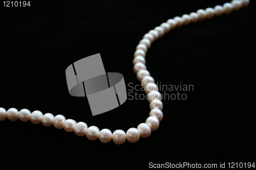 Image of pearls necklace on the black background