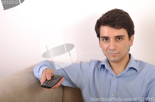 Image of Smiling man watching tv