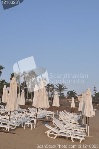 Image of Beach chairs and umbrellas