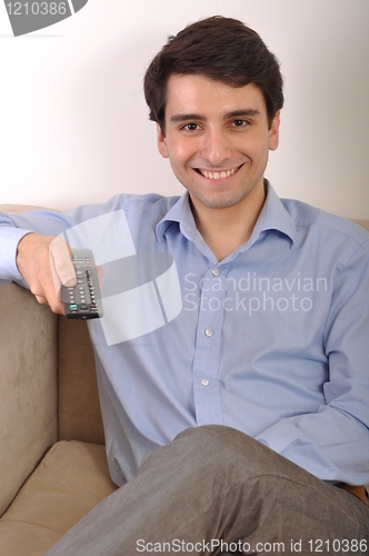 Image of Smiling man watching tv
