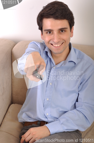 Image of Smiling man watching tv