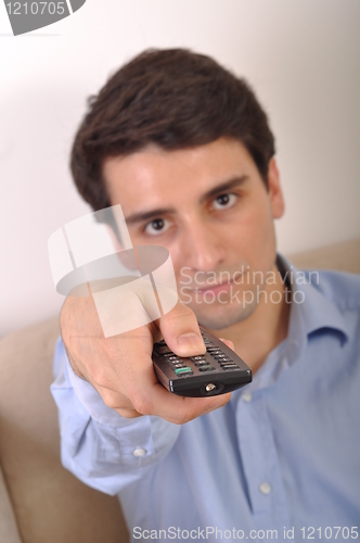 Image of Smiling man watching tv