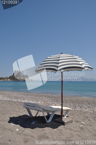 Image of Beach umbrella and chair