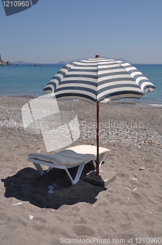 Image of Beach umbrella and chair