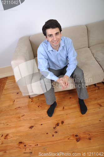 Image of Man sitting on the couch