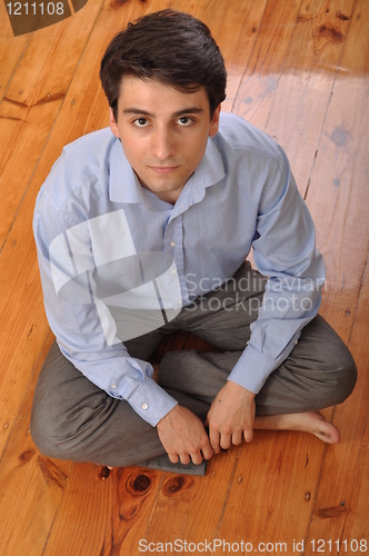 Image of Man sitting on the floor