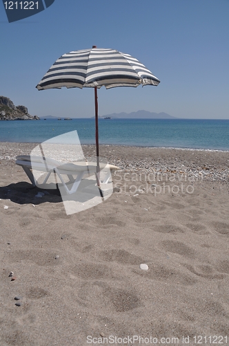 Image of Beach umbrella and chair