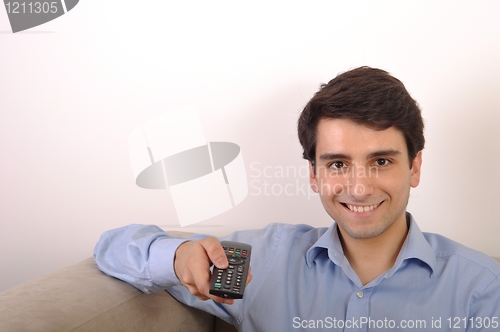 Image of Smiling man watching tv