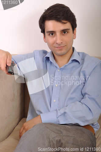 Image of Smiling man watching tv