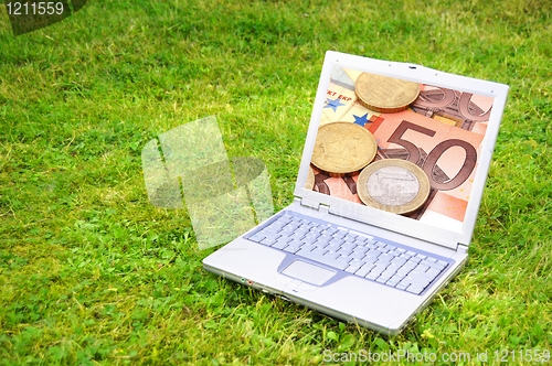 Image of laptop and money