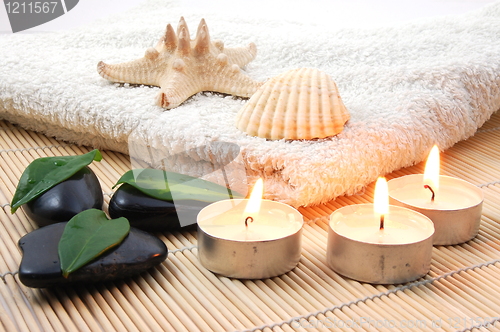 Image of foldet white bath towel and zen stones