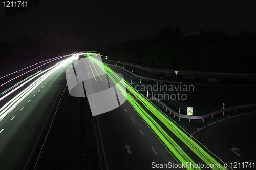 Image of road with car traffic at night with blurry lights