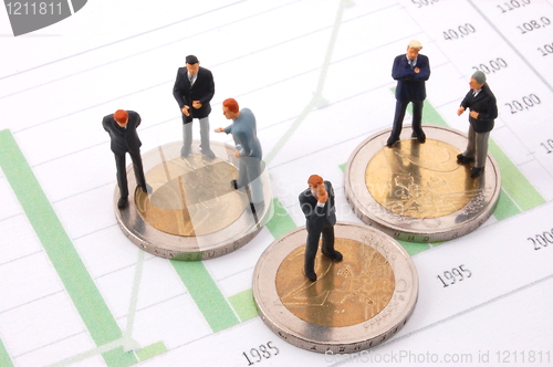 Image of businessman and money over a chart