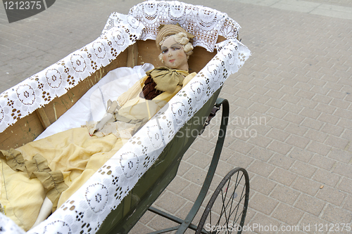 Image of Doll in a pram.