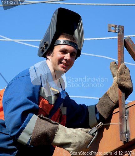 Image of A welder working at height