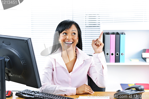Image of Businesswoman having idea at desk