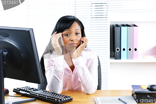 Image of Worried black businesswoman at desk