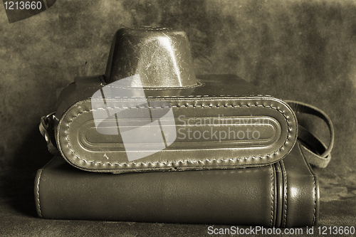 Image of old camera in leather case and notebook