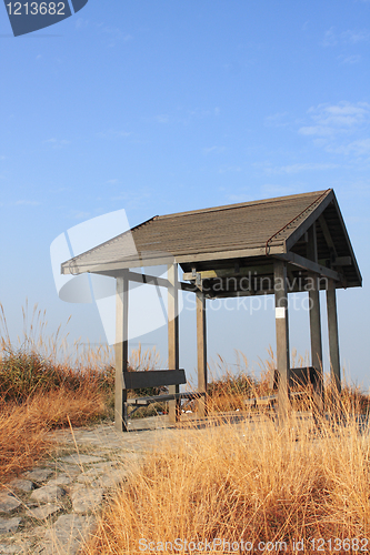 Image of pavilion on the grassland with blue sky. 
